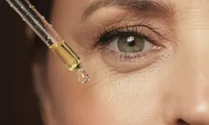 Gota de aceite con vinagre de manzana para la cara, aplicada cerca del ojo.