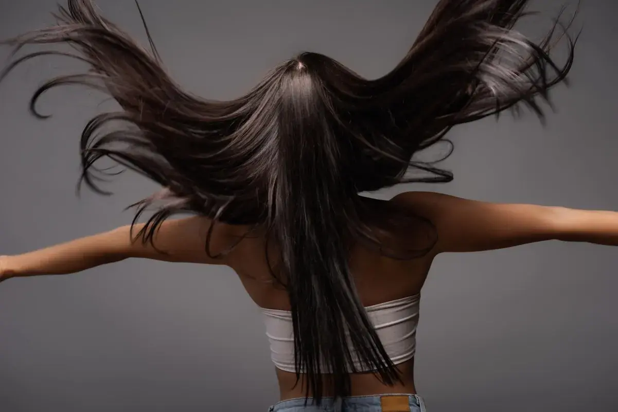 Cabello oscuro y sedoso moviéndose con gracia. Descubre qué es la taninoplastia y cómo puede transformar tu melena.